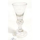 A Baluster Wine Glass, circa 1730, the conical bowl on a baluster stem with air tear and domed