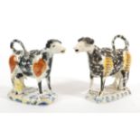 A Matched Pair of Pearlware Cow Creamers and Stoppers, circa 1820, the standing beasts with black