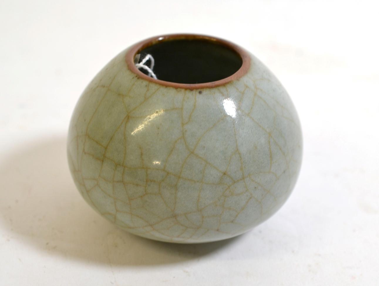 A Chinese Guan Type Lotus Bud Water Pot, Qing Dynasty, with allover crackling to the glaze, 7cm high