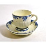 A St Cloud Porcelain Coffee Cup and Trembleuse Saucer, circa 1740, of fluted form, painted in