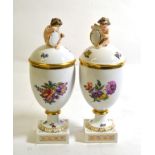 ~ A Pair of Royal Copenhagen Porcelain Urn Shaped Vases and Covers, late 19th century, with cherub