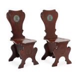 ~ A Pair of George III Mahogany Hall Chairs, circa 1800, each of sgabello form, the solid back