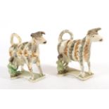 A Creamware Cow Creamer and Stopper, circa 1820, the standing beast with green and ochre sponged