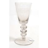 A Baluster Glass Goblet, circa 1740, the rounded funnel bowl on a triple knopped stem with air