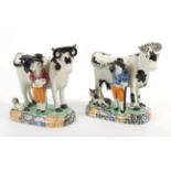 A Yorkshire Pratt Type Pottery Cow Group, circa 1810, the standing beast with black markings, a