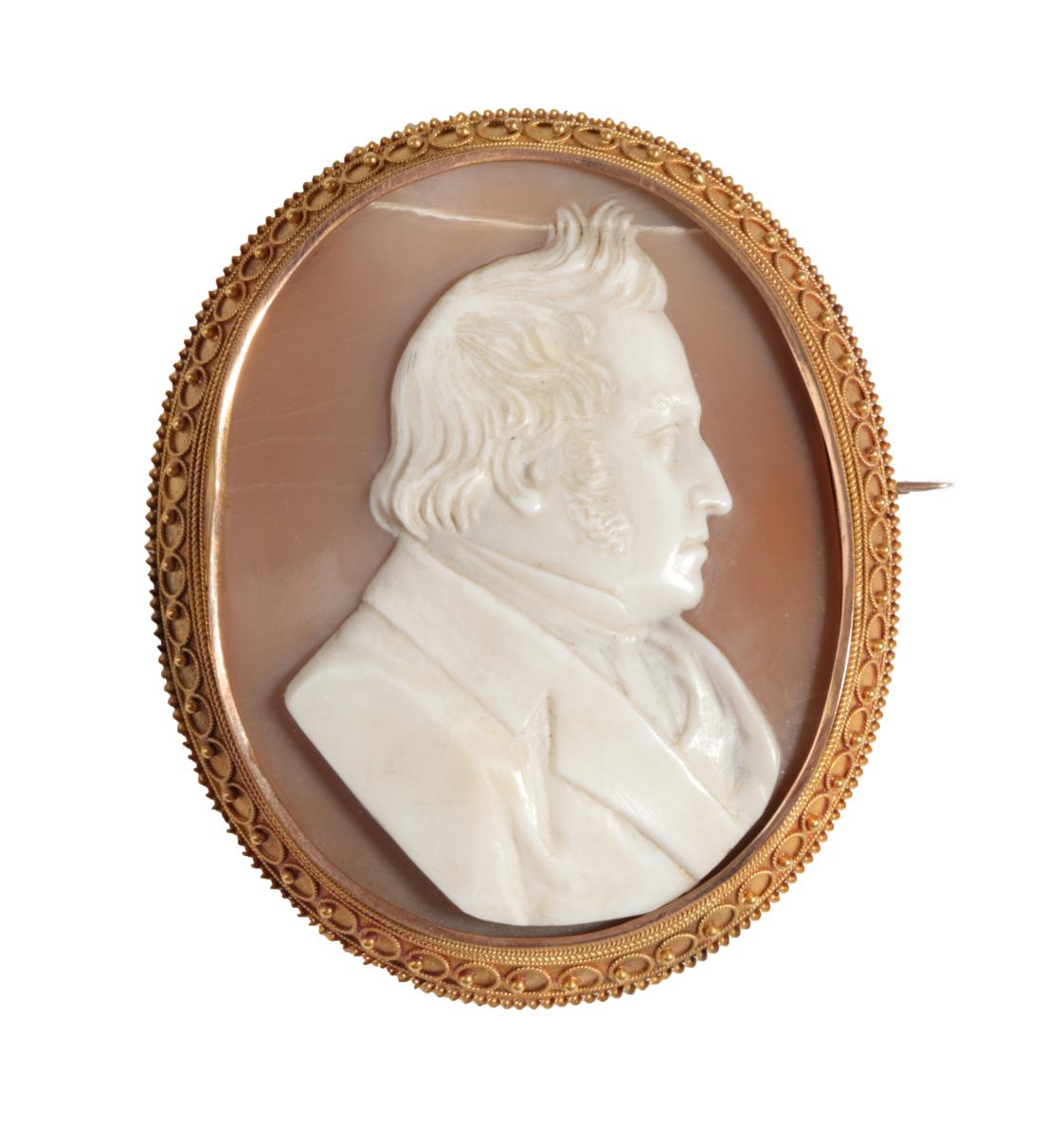 A Victorian Cameo Brooch, the shell carved to depict a gentleman, a picture enclosed in the locket