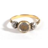 A Mourning Ring, circa 1800, a faceted rock crystal cover entwined hair and a monogram, in a