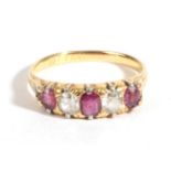 A Late Victorian 18 Carat Gold Ruby and Diamond Five Stone Ring, three graduated cushion cut