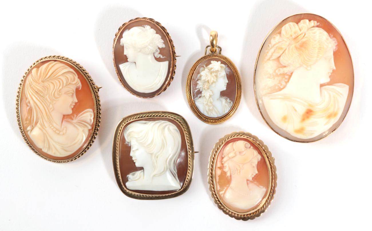 A Cameo Brooch, depicting three figures at a lyre, within an oval rope twist frame, measures 4.7cm