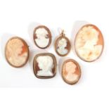 A Cameo Brooch, depicting three figures at a lyre, within an oval rope twist frame, measures 4.7cm