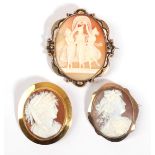 Three Cameo Brooches, one depicting the three Graces, within a scrolling frame, measures 5.5cm by