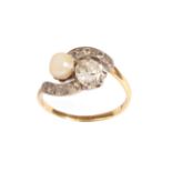 An 18 Carat Gold Cultured Pearl and Diamond Two Stone Twist Ring, in claw settings with old cut