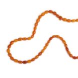 An Amber Coloured Necklace, graduated polished beads of varying degrees of opacity and colour,