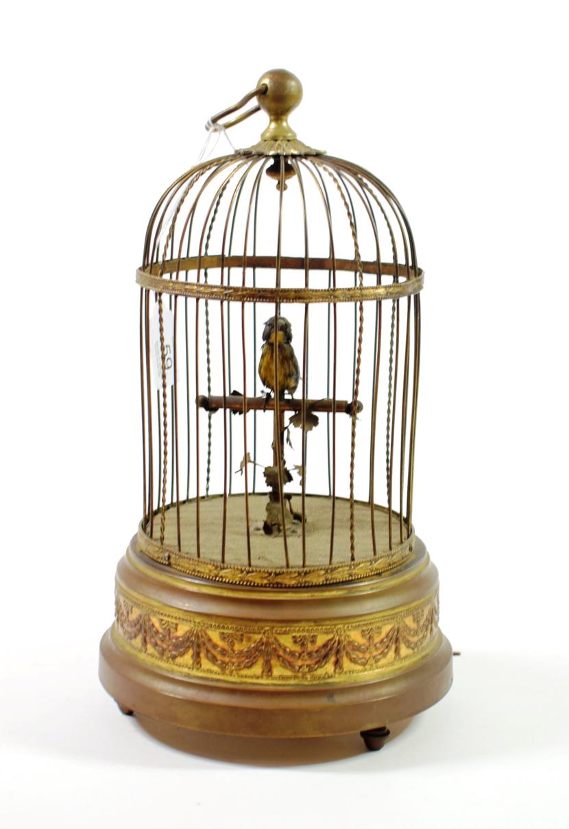 A Singing Bird Automaton, late 19th/early 20th century, in a domed gilt wirework cage on a