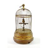 A Singing Bird Automaton, late 19th/early 20th century, in a domed gilt wirework cage on a