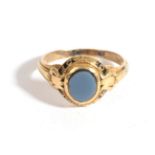 An Agate Memorial Ring, an oval horizontally banded agate within a frame with black enamel to