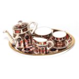 ~ A Royal Crown Derby Imari Pattern Miniature Tea Service, comprising a teapot and cover, milk