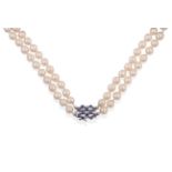 A Two Row Cultured Pearl Necklace, the 45:49 pearls knotted to an oblong clasp set with sapphires in