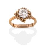 A Diamond Solitaire Ring, the old cushion cut diamond in white claws, within an asymmetric beaded