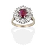 An 18 Carat White Gold Ruby and Diamond Cluster Ring, an oval cut ruby within a border of round