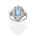 An Aquamarine and Diamond Cluster Ring, the baguette cut aquamarine within a border of old cut