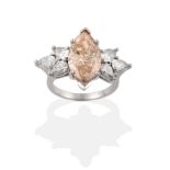 A Fancy Diamond Ring, a light brown marquise cut diamond within two spray clusters of three pear cut
