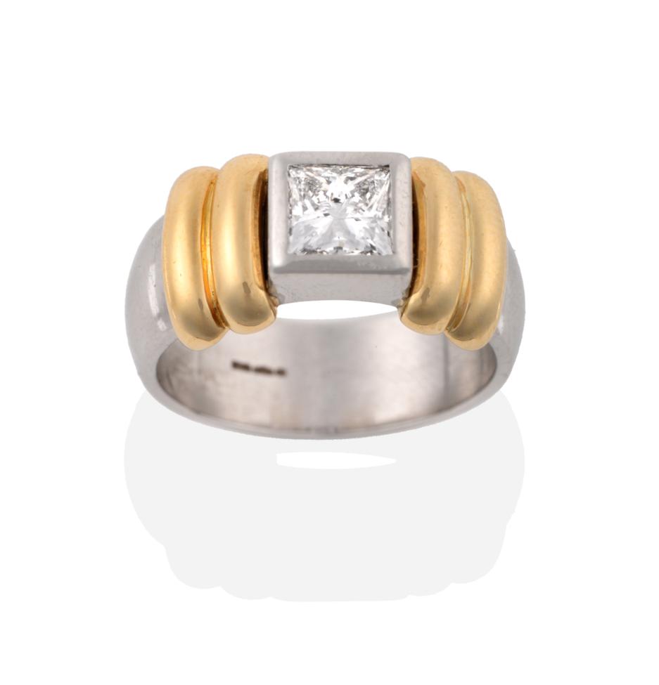 A Contemporary Platinum Diamond Solitaire Ring, the princess cut diamond in a rubbed over setting,