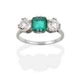 An Emerald and Diamond Three Stone Ring, the octagonal step cut emerald flanked by two old cut