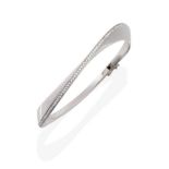 An 18 Carat White Gold Diamond Set Bangle, in a twisting form, with a line of round brilliant cut