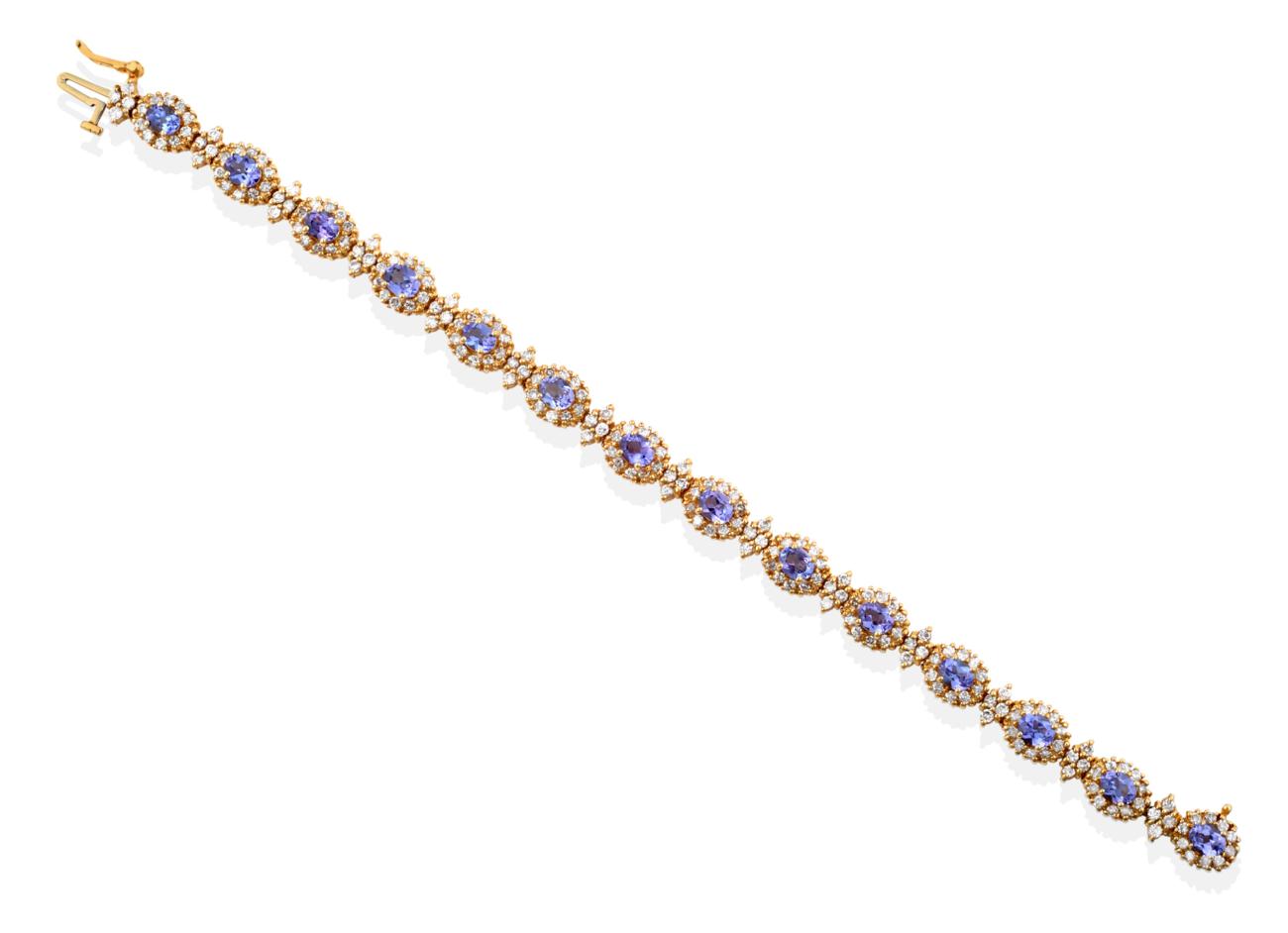 A Tanzanite and Diamond Cluster Bracelet, fourteen oval mixed cut tanzanite and round brilliant