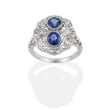 A Sapphire and Diamond Cluster Ring, two round mixed cut sapphires in white rubbed over settings