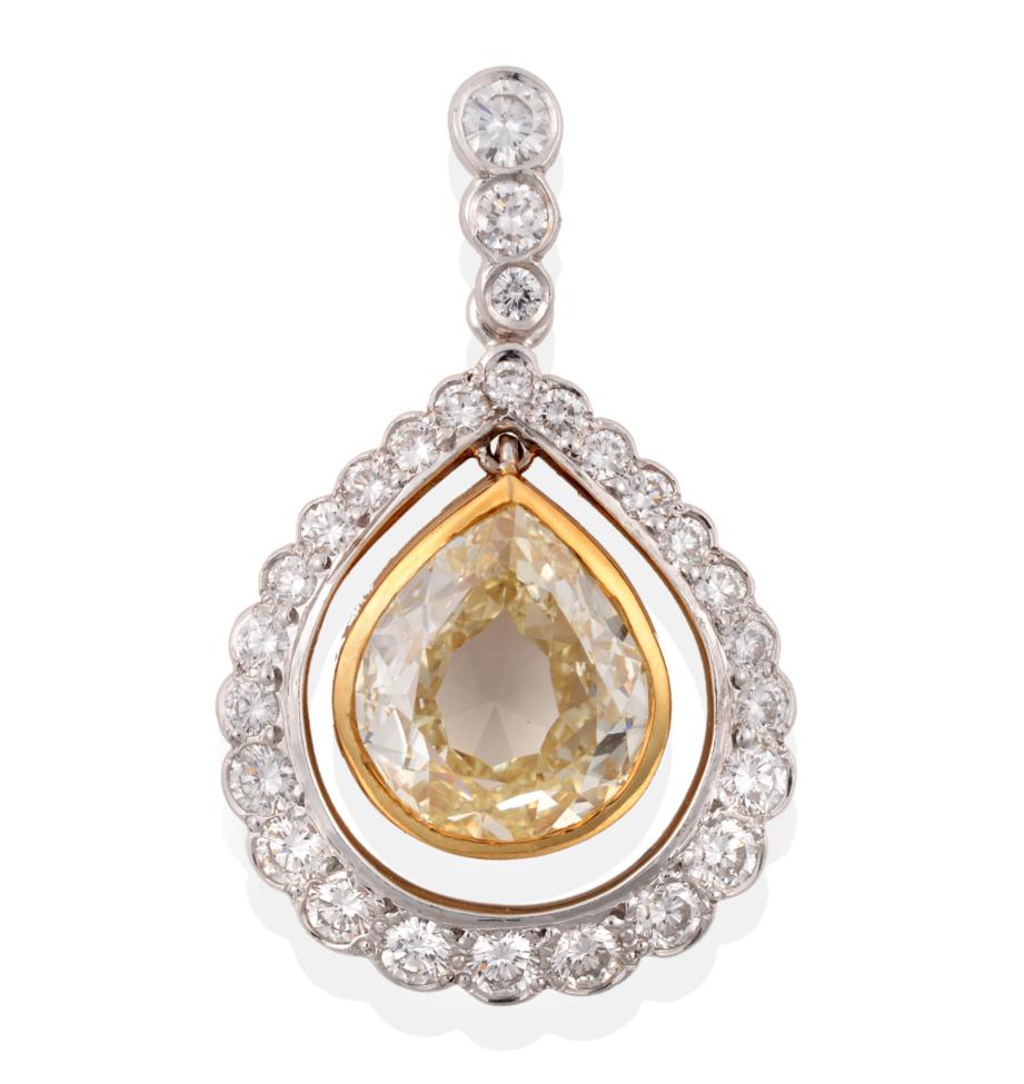 A Yellow and White Diamond Cluster Pendant, a pear cut yellow diamond in a yellow rubbed over