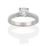 A Platinum Diamond Solitaire Ring, the round brilliant cut diamond in a four claw setting to pointed