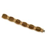 An 18 Carat Gold Tiger's-Eye Bracelet, six oval panels in raised frames, length 18.5cm see