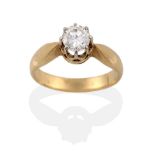 A Diamond Solitaire Ring, the round brilliant cut diamond in a white claw setting, to a yellow
