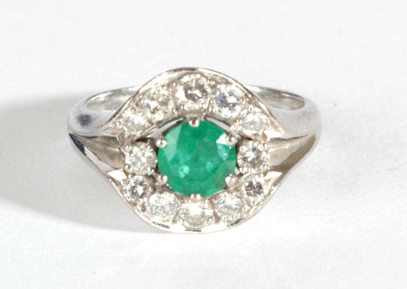 A Contemporary Emerald and Diamond Cluster Ring, a round cut emerald flanked by two round - Image 3 of 4