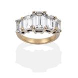 A Diamond Five Stone Ring, set with graduated emerald cut diamonds in white claw settings, on a