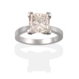 A Platinum Diamond Solitaire Ring, the princess cut diamond in a four claw setting to knife edge