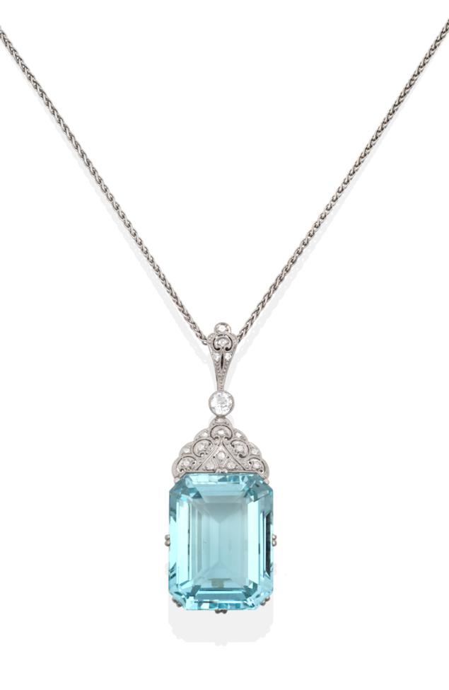 An Aquamarine and Diamond Pendant on Chain, the emerald-cut aquamarine in a claw setting, surmounted