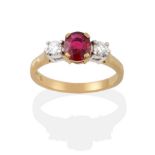 An 18 Carat Gold Ruby and Diamond Three Stone Ring, the oval mixed cut ruby in a yellow claw setting