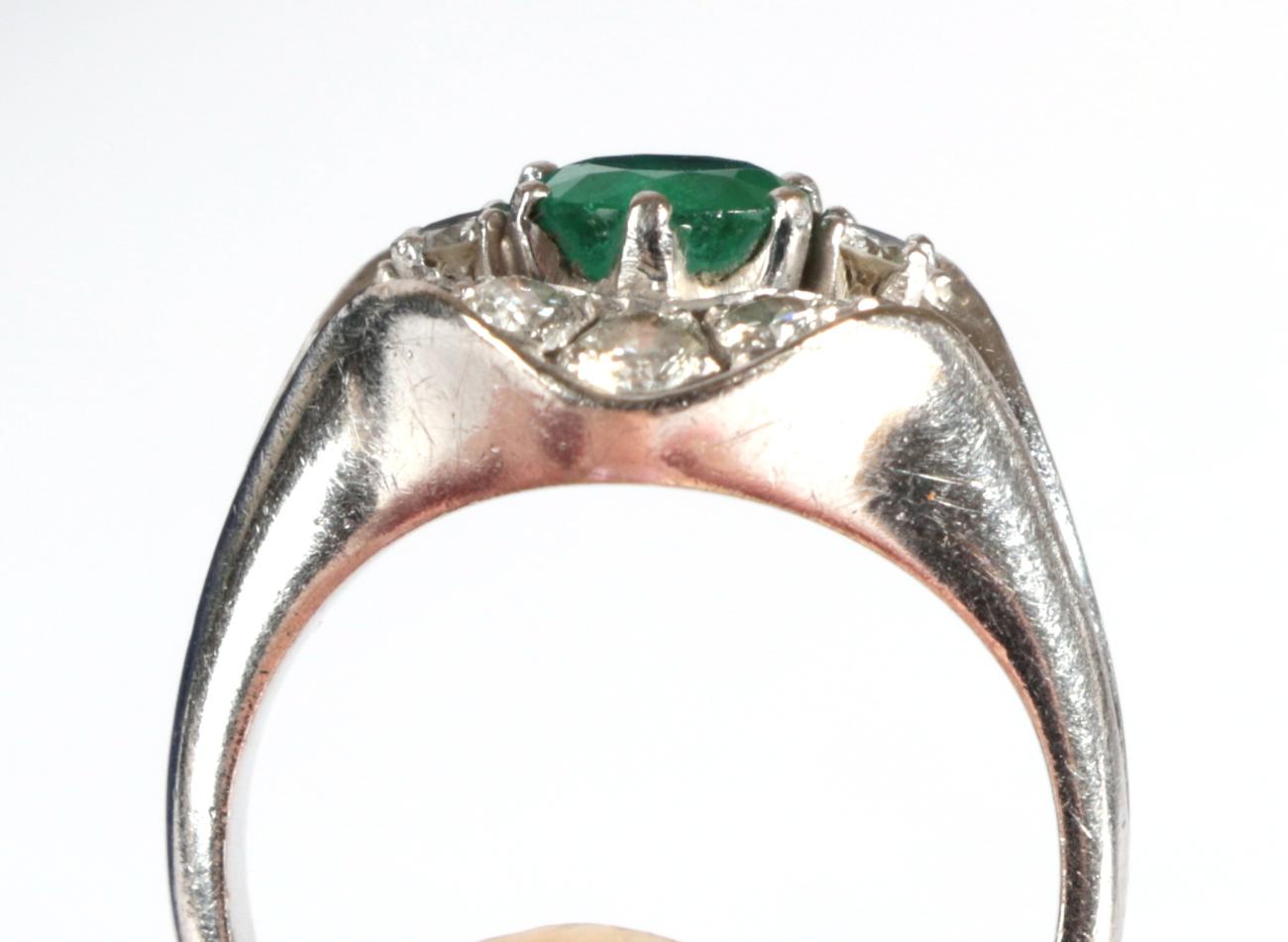 A Contemporary Emerald and Diamond Cluster Ring, a round cut emerald flanked by two round - Image 4 of 4