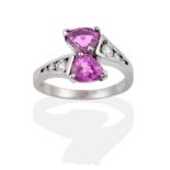 An 18 Carat White Gold Pink Sapphire and Diamond Crossover Ring, two pear cut sapphires create the