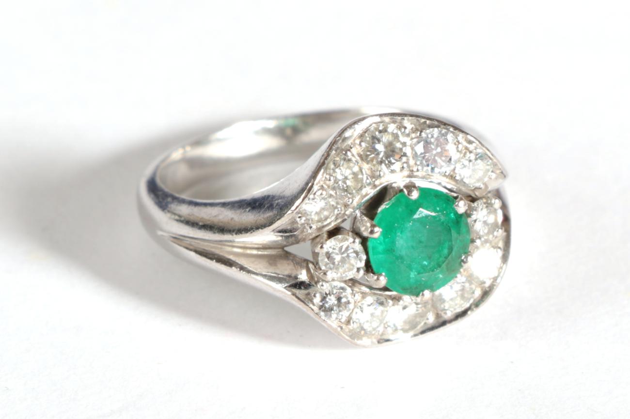 A Contemporary Emerald and Diamond Cluster Ring, a round cut emerald flanked by two round - Image 2 of 4