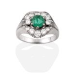 A Contemporary Emerald and Diamond Cluster Ring, a round cut emerald flanked by two round