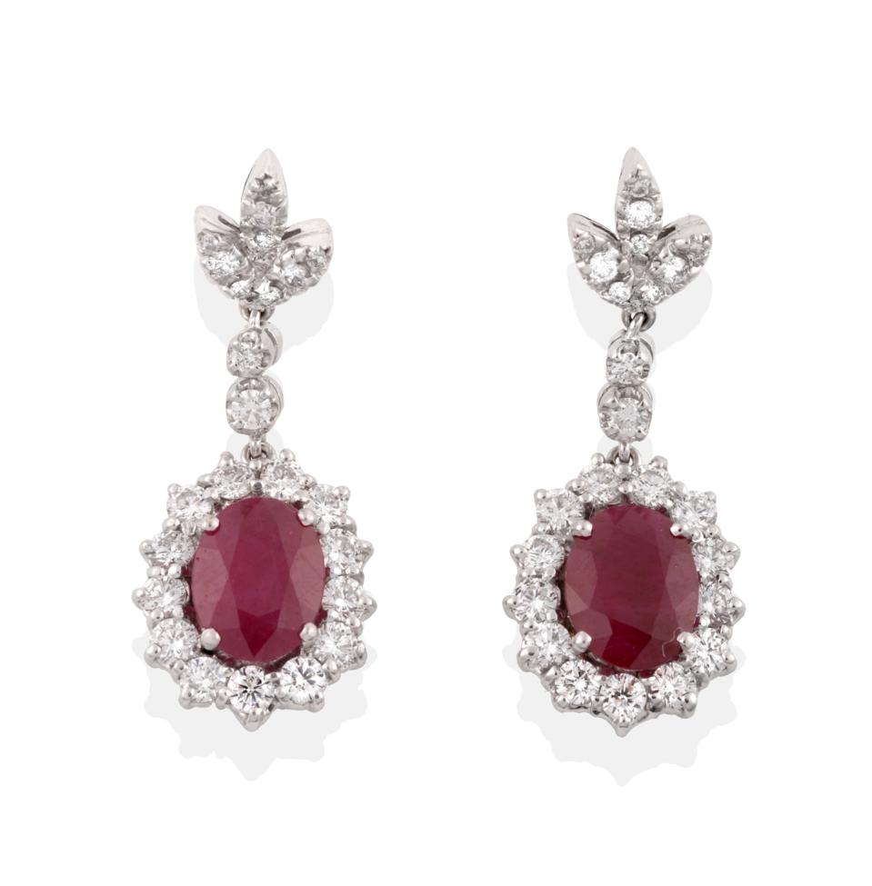 A Pair of Ruby and Diamond Drop Earrings, a triple leaf motif of round brilliant cut diamonds