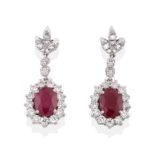 A Pair of Ruby and Diamond Drop Earrings, a triple leaf motif of round brilliant cut diamonds