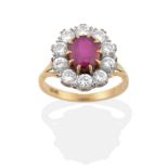 A Ruby and Diamond Cluster Ring, an oval cut ruby in yellow claw settings, within a border of