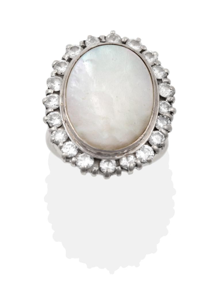 A Mother-of-Pearl and Diamond Cocktail Ring, the flat mother-of-pearl in a white collet setting,