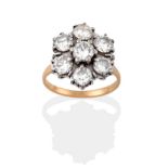 An 18 Carat Gold Diamond Cluster Ring, seven round brilliant cut diamonds in white claw settings, to