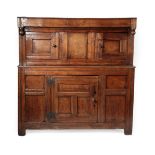 An 18th Century Joined Oak Cupboard, dated 1716, the boarded top above inverted turned finials,